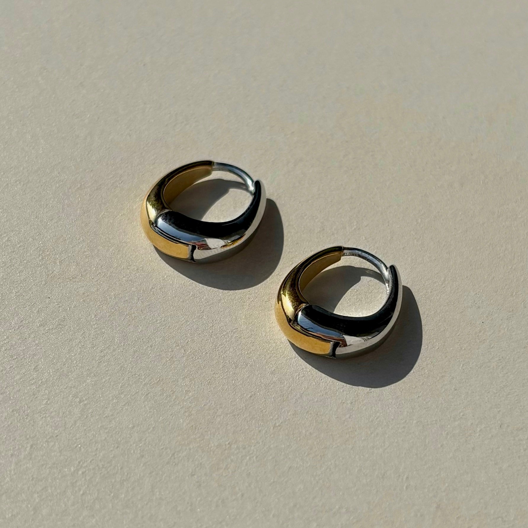 Introducing the Nine hoops from our SS24 collection: versatile mixed-metal earrings. Available in three shapes blending gold and silver.